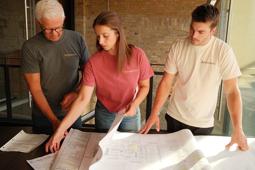 Mirana team looking at blueprints